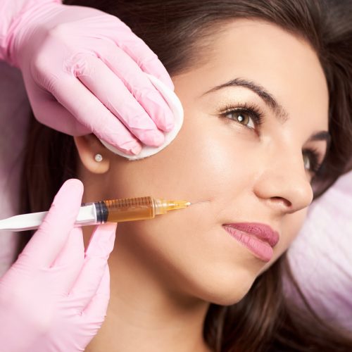 Close-up of beautiful woman getting injection in the cosmetology salon
